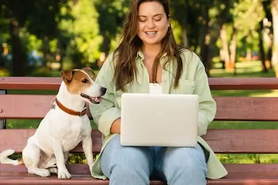 woman andl dog  outside with laptop